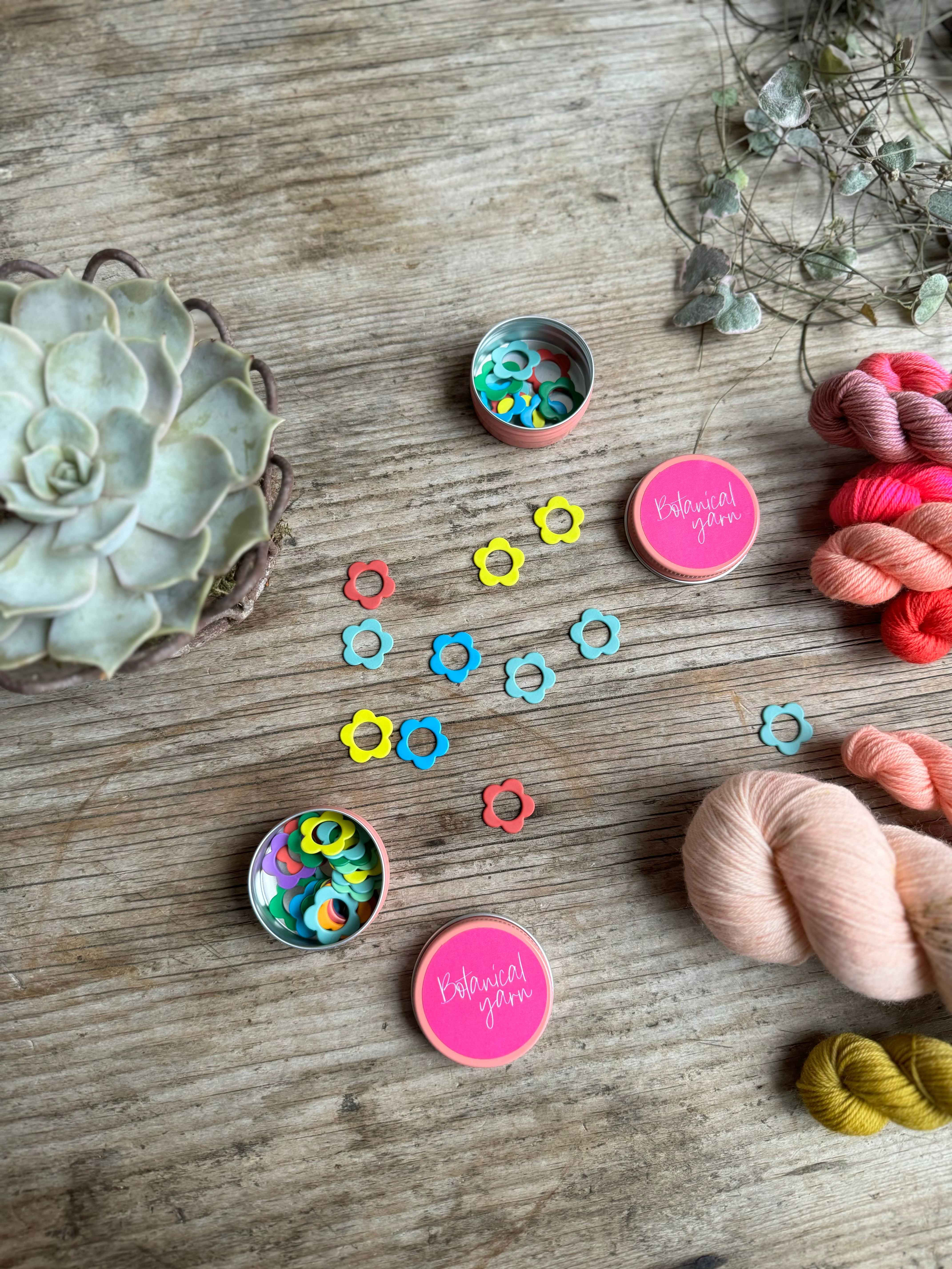 Five petal flower stitch markers in tin