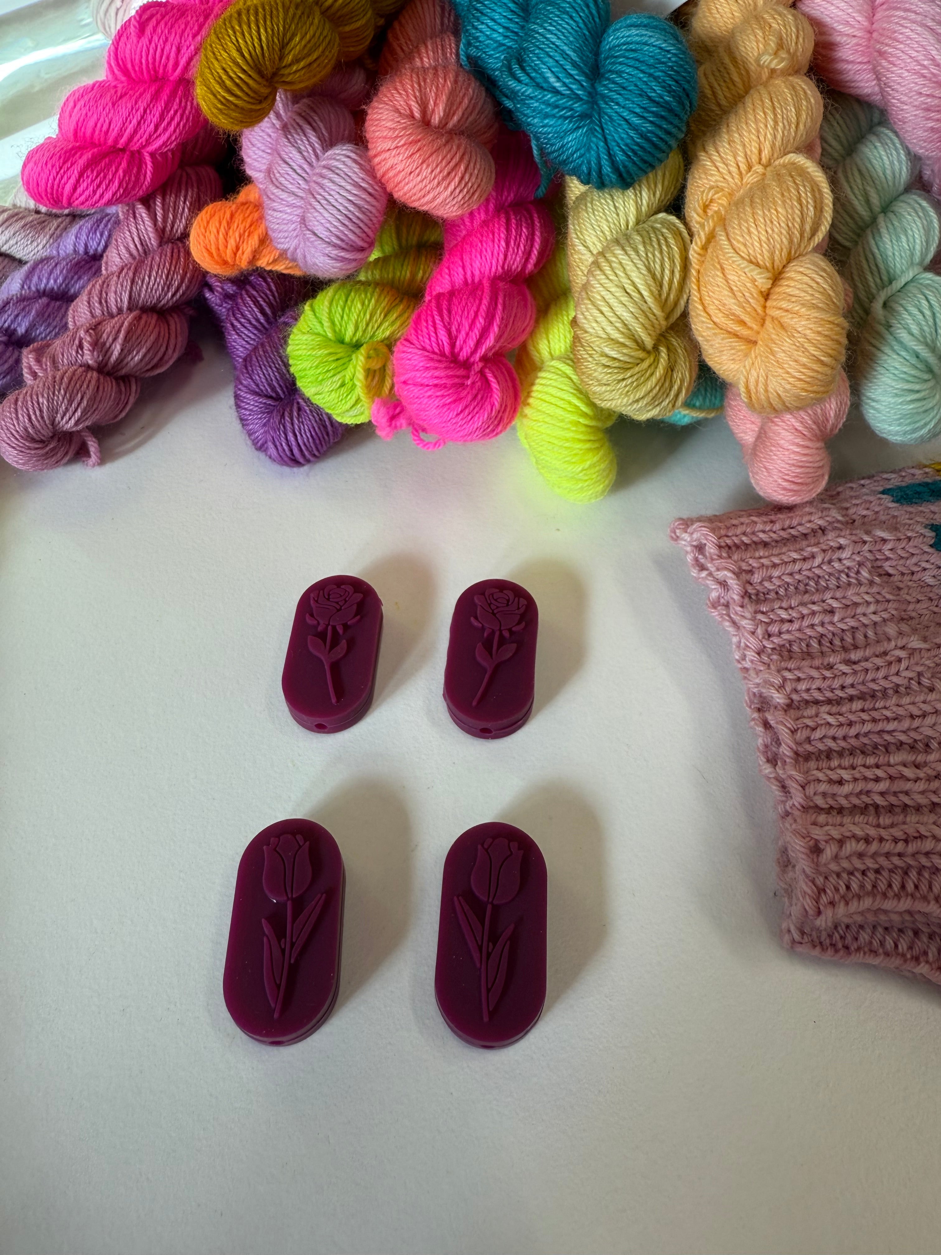 Knitting needle stitch stoppers